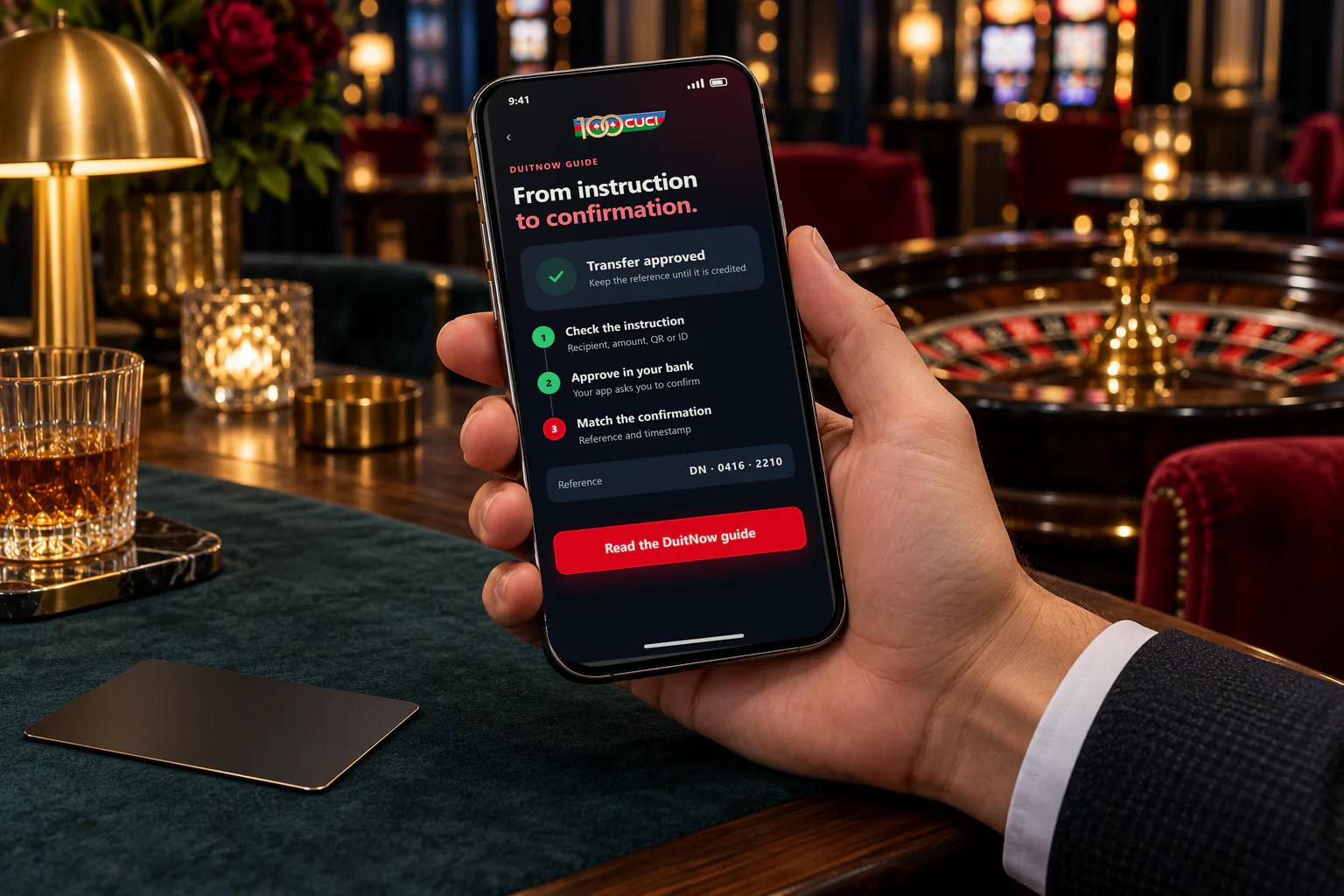 A hand holding a phone showing the 100cuci DuitNow guide, from instruction to confirmation, in a casino lounge